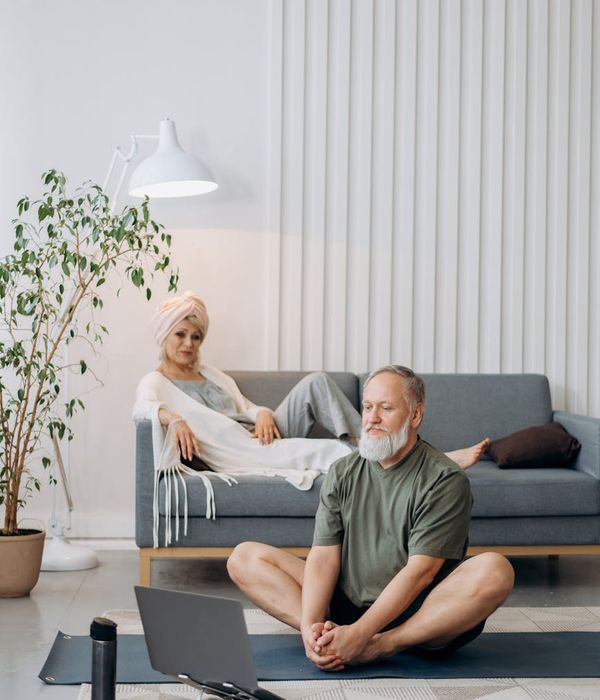 Person sitting in a calm, well-lit room, looking peacefully into the distance.